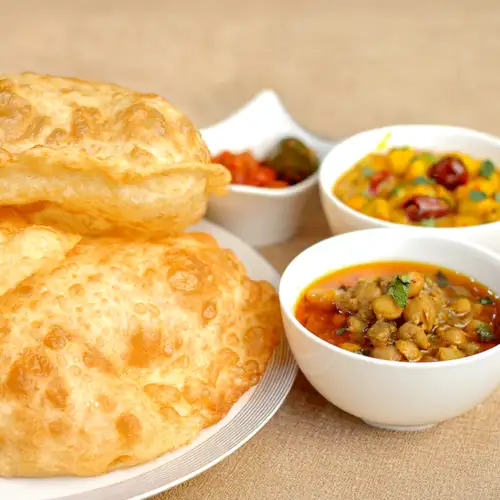 Halwa puri with aloo tarkari, chana tarkari and achaar from New Dilpasand Sweets, Karachi